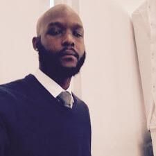 Jay Montgomery in a dark sweater and tie